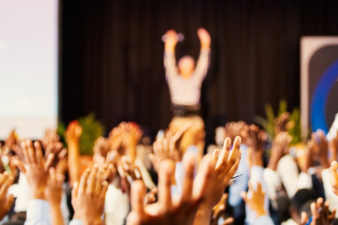 Speaker engaging with a business audience at a conference